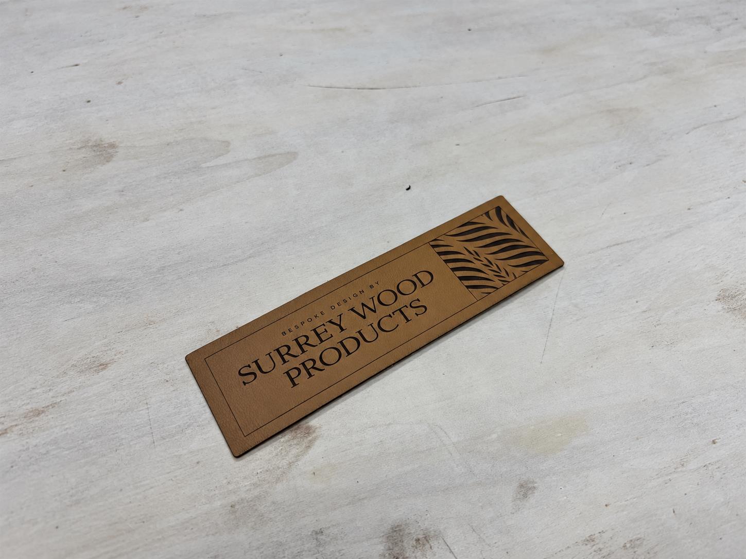 Brown nameplate with Surrey Wood Products lettering and a leaf design