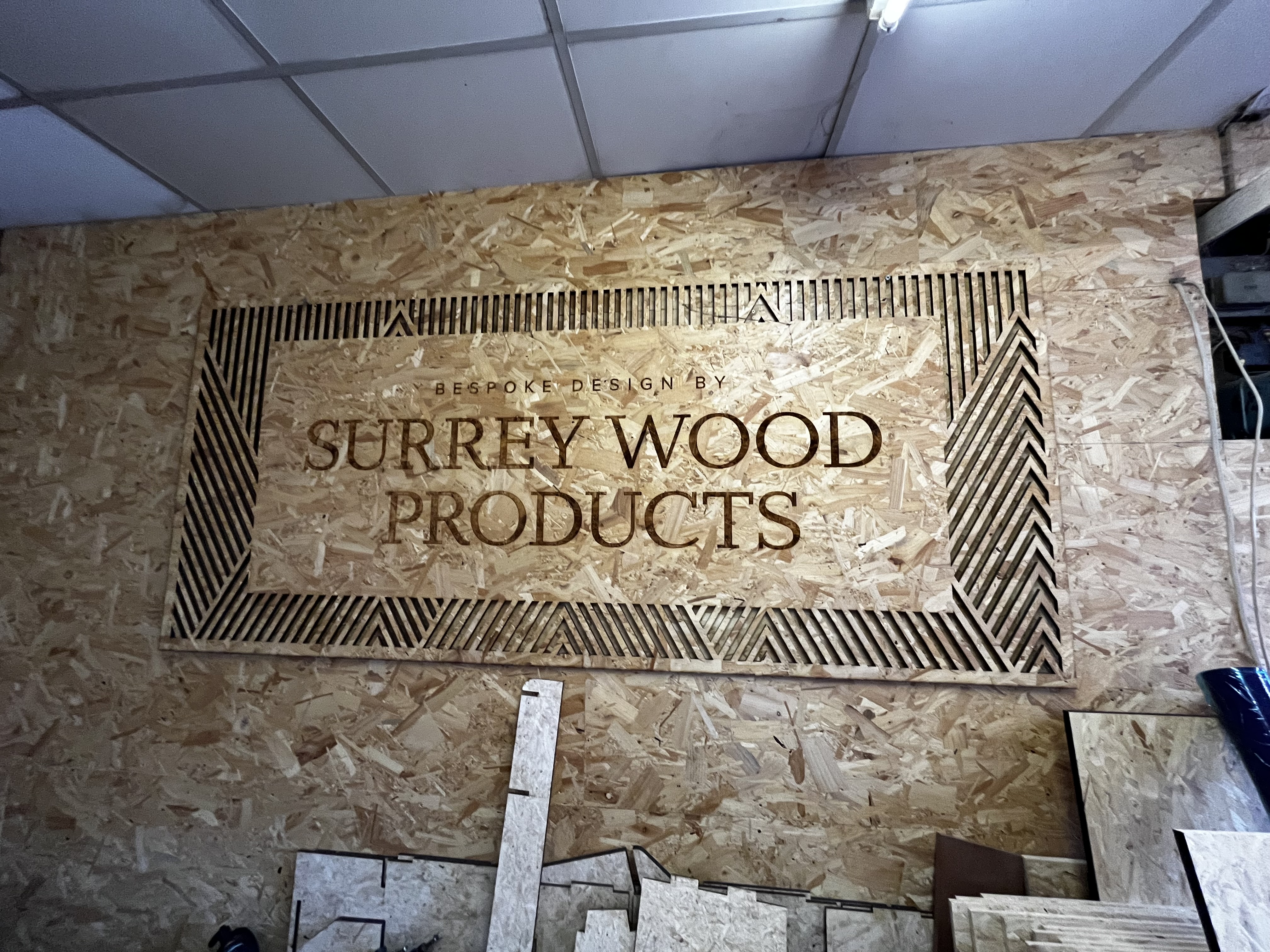 Surrey Wood Products workshop sign with cut border detailing